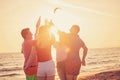 Group of happy young people dancing at the beach on beautiful summer sunset Royalty Free Stock Photo