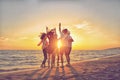 Group of happy young people dancing at the beach on beautiful summer sunset Royalty Free Stock Photo