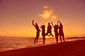 Group of happy young people dancing at the beach on beautiful summer sunset Royalty Free Stock Photo
