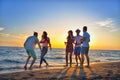 Group of happy young people dancing at the beach on beautiful summer sunset Royalty Free Stock Photo