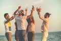 Group of happy young people dancing at the beach on beautiful summer sunset Royalty Free Stock Photo