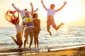 Group of happy young people dancing at the beach on beautiful summer sunset Royalty Free Stock Photo