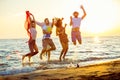 Group of happy young people dancing at the beach on beautiful summer sunset Royalty Free Stock Photo