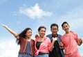 Group of happy young people with hands up and cheers