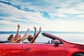 Group of happy people in red convertible car Royalty Free Stock Photo