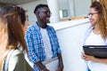 Group of happy young students speaking in a university. Royalty Free Stock Photo