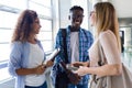 Group of happy young students speaking in a university. Royalty Free Stock Photo