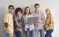 Group of happy young IT students using laptop computer, smiling and looking at camera Royalty Free Stock Photo