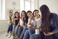 Group of happy young women enjoying coffee and listening to each other's stories Royalty Free Stock Photo