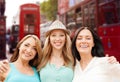 Group of happy young women over london city street Royalty Free Stock Photo