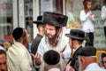 A group of Hasidim pilgrims in traditional clothing emotionally talk. Rosh hashanah holiday, Jewish New Year.