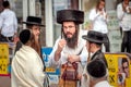 A group of Hasidim pilgrims in traditional clothing emotionally talk. Rosh hashanah holiday, Jewish New Year.