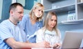 Group of healthcare workers with laptop working together in office. Royalty Free Stock Photo