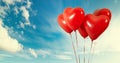 Group of heart shaped red air baloon on blue sky with clouds. Valentines day and romance concept. Royalty Free Stock Photo