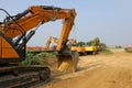 Group of heavy excavators at work to install a natural gas pipeline