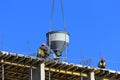 A group of high-rise assemblers work on the top floor of a construction site.