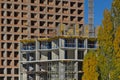 A group of high-rise assemblers work on the top floor of a construction site.