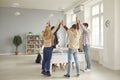 Group of high school or college students standing in classroom and holding hands