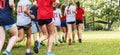 Many girls running on grass in a park