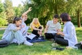 Group of high school students with female teacher, on campus lawn Royalty Free Stock Photo