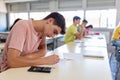 Group of high school students having test exam at classroom