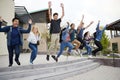 Group Of High School Students Jumping In Air Outside College Buildings Royalty Free Stock Photo