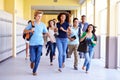 Group Of High School Students Running In Corridor Royalty Free Stock Photo