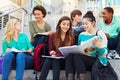 Group Of High School Students Sitting Outside Building Royalty Free Stock Photo