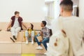 group of high school students sitting at school corridor