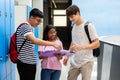 Group of high school students talking happily and discussing at corridor Royalty Free Stock Photo