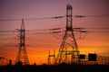 Group of high-voltage electricity power pylons during sunset Royalty Free Stock Photo