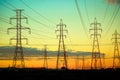 Group of high-voltage electricity power pylons during sunset Royalty Free Stock Photo