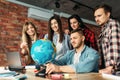 Group of highschool students looking at the globe Royalty Free Stock Photo