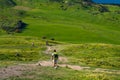 A group of hiker hiking on the beautiful track with a landscape of the mountains and Lake Wanaka. Roys Peak Track, South Island,