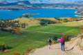 A group of hiker hiking on the beautiful track with a landscape of the mountains and Lake Wanaka. Roys Peak Track, South Island,