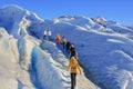 Group of hiker people making amazing trekking at ice surface of melting Perito Moreno Glacier, Patagonia Argentina Royalty Free Stock Photo