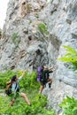 Group Hiker woman helping her friend climb up the last section in mountains.