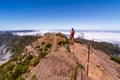 Group of hikers admiring view at Pico Ruivo peak, Madeira, Portugal.