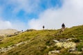 Group of hikers ascending top of Pietrosul Rodnei mountain. Mountain ridge slopes of Rodna Mountains National Park multiday hike, Royalty Free Stock Photo