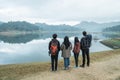 Group hikers with backpacks enjoying lake view