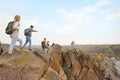 Group of hikers with backpacks at top of mountain