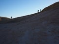 Group of  hikers crossing rocky hills in the desert Royalty Free Stock Photo