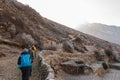 Hikers walking on a trail in Nepal Royalty Free Stock Photo