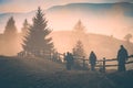 Group of hikers in a misty mountain valley. Instagram stylisation Royalty Free Stock Photo