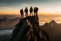 Group of hikers standing on top of a mountain and looking at sunrise, A team of climbers at the top of a high mountain in the Royalty Free Stock Photo