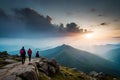 A group of hikers taking a break on a rocky outcrop, enjoying a breathtaking view of a mountain range in the distance Royalty Free Stock Photo