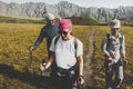 Group Of Hikers Walking Along The Plain In Summer Mountains, Journey Travel Trek Concept