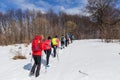 Group of hikers walking on the hike trail on snow