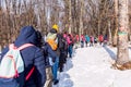 Group of hikers walking on the hike trail on snow