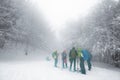 Group Hikers Walking On Trail Snow Covered And Foggy